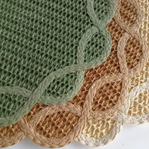 Macro view of woven paper placemats showing intricate straw texture and scalloped edges