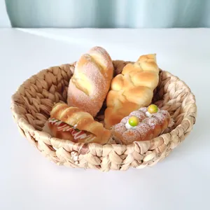 Handgeweven waterhyacint opbergmand, ronde rieten broodmand en bureau-organizer voor thuisdecoratie.