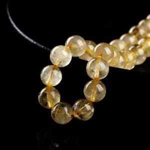 High-quality natural golden rutilated quartz round beads for DIY jewelry making and bracelets.