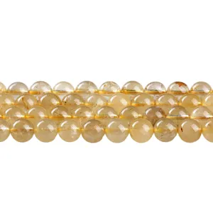 Natural golden rutilated quartz round beads for DIY jewelry making in a neat row display