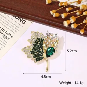 Detailed view of crystal maple leaf brooch with dimensions 5.2cm x 4.8cm and 14.1g weight