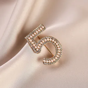 Elegant vintage number 5 pearl rhinestone brooch, chic gold coat accessory for women.