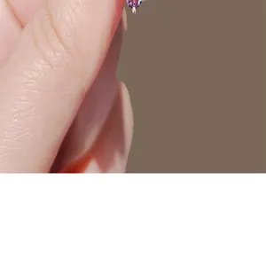 Close-up detail of an elegant purple crystal heart brooch pin for clothing adjustment