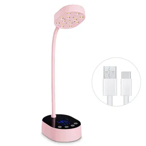 Pink rechargeable LED nail lamp with a detailed view of its USB charging cable