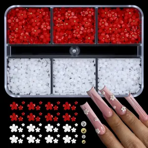 Detailed view of red and white 5-petal resin nail art charms in a 6-grid organizer box