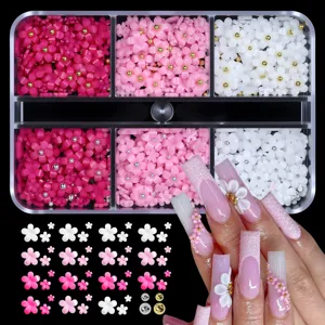 Detailed macro view showing assorted 3D resin flower nail charms and professional manicure