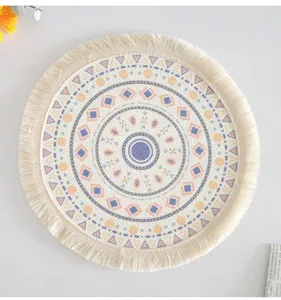 Macro view of bohemian round cotton woven placemat with mandala print and tassel fringe