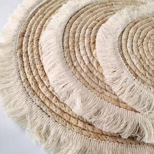 Natural corn husk woven placemat with elegant fringe edge, modern minimalist round table mat.