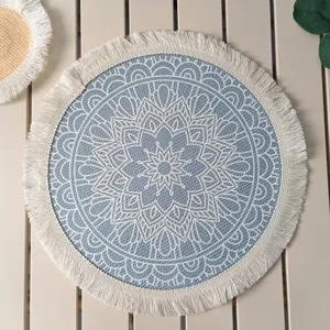Macro view of bohemian blue mandala printed placemat featuring delicate white cotton fringes