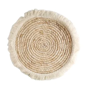 Round woven straw placemat with fringe, natural corn husk table mat for dining room.