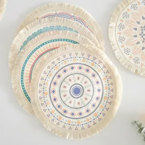 Set of bohemian woven cotton round placemats with geometric patterns and fringe detail