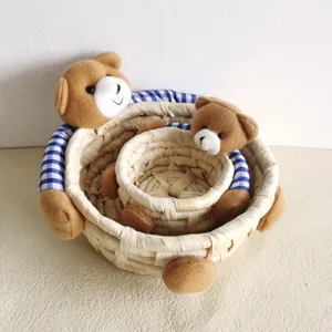 Cute straw corn husk nesting storage baskets with plush teddy bear decorations for home decor.