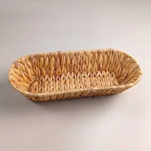 Natural hand-woven oval straw storage basket for serving snacks, fruit, and bread
