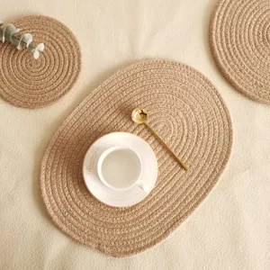 Detailed view of handmade oval braided jute placemat with natural hemp fiber texture