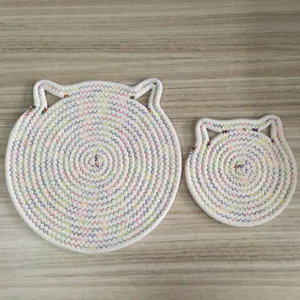 Macro view of handmade cat ear cotton rope mats with vibrant zig-zag stitching