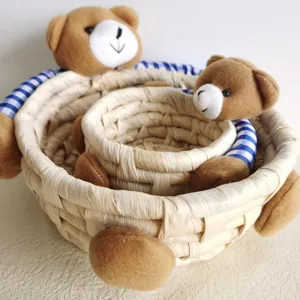 Cute corn husk woven storage basket set with adorable bear decor for home organization.