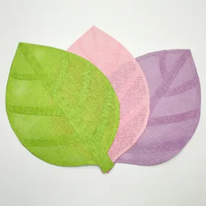 Detailed view of colorful leaf-shaped woven placemats in green pink and purple tones.