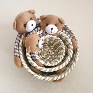 Detailed closeup view of cute woven corn husk storage basket with adorable plush bear decor.