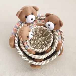 Charming nesting straw storage baskets featuring cute plush teddy bear decor for home organization.