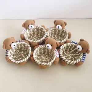 Cute corn husk woven storage basket with plush teddy bear decor for desktop organization.