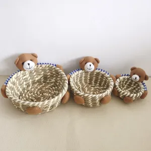 Detailed close-up of handmade straw storage baskets featuring cute plush teddy bear decor.