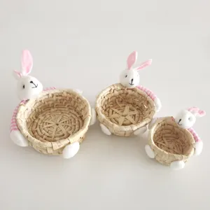 Cute straw woven storage basket with plush bunny ears, great for Easter candy and desktop org.