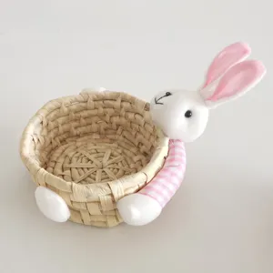 Cute woven straw storage basket featuring plush bunny for holding small items and candies.