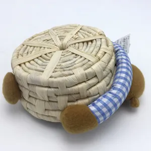Cute corn husk woven storage basket with plush bear ears and blue plaid handle for desk tidy