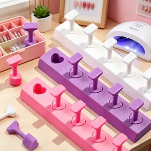 Macro detail of heart-shaped nail practice stands in pink and purple macaron colors.