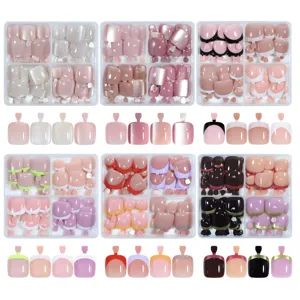 Detailed view of assorted cat eye and French tip press-on toenails in stylish gift boxes