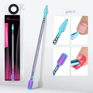 Detail of dual-ended stainless steel manicure tool with rainbow titanium finish.