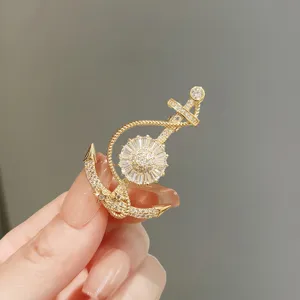 Exquisite anchor brooch detail shot, sparkling crystal paved design, elegant accessory.