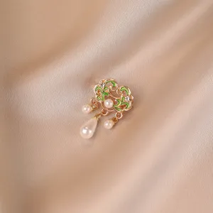 Detailed macro shot of a retro Chinese style auspicious cloud pearl brooch on silk background