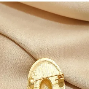 Detailed view of vintage gold hat brooch back pin, elegant suit accessory for women