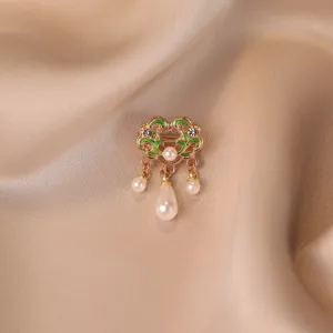 Close-up of vintage Chinese style auspicious cloud lock brooch with pearls on satin