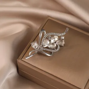 Close-up of a luxury vintage wheat-ear silver brooch with teardrop clear crystals