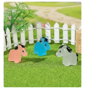 Detailed view of colorful luminous pony figurines in a garden micro-landscape scene