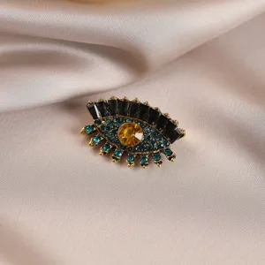 Squisita spilla vintage a forma di occhio con strass neri, blu e gialli per stile chic.