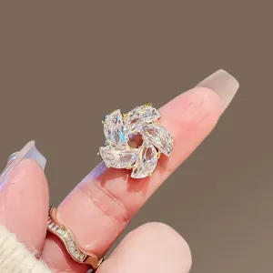 Exquisite small flower crystal brooch and anti-glare pin detail shot, elegant lapel accessory.