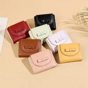 Collection of colorful women's short wallets with bow decoration and white stitching detail