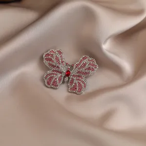 Exquisite butterfly brooch detail, sparkling rhinestones, elegant accessory for outfits.