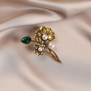 Vintage gold alloy lotus flower brooch with pearls and green emerald gemstone