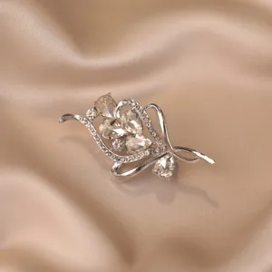 Close-up of luxury vintage silver alloy brooch with champagne crystals on champagne satin