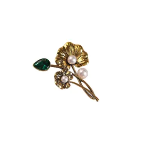 Vintage style gold-tone lotus leaf alloy brooch featuring pearls and green gemstone
