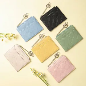 Slim quilted card holder wallet with zipper closure and keychain in various pastel colors.