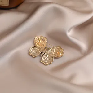 Exquisite gold alloy butterfly brooch back view, elegant accessory for clothing and hats.