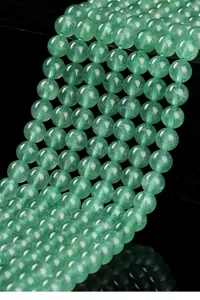 Close-up of 8mm natural green strawberry quartz loose round beads for DIY jewelry