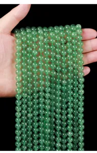 Macro view of 8mm natural green strawberry quartz beads for handmade DIY jewelry accessories