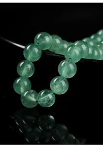 Macro view of 8mm green strawberry quartz round beads showing natural crystal texture