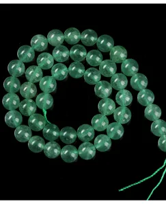 Macro detail of natural green strawberry quartz 8mm round loose beads for DIY jewelry